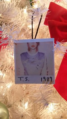 an ornament hanging from the top of a christmas tree