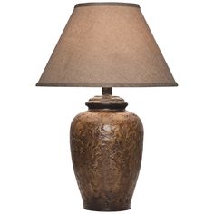 a table lamp with a brown base and a beige shade on the top of it