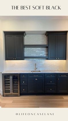 a kitchen with black cabinets and white tile backsplash, the best soft black