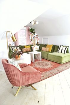 a living room filled with furniture and a large rug on top of a hard wood floor