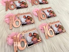 six personalized photo magnets with pink bows on a white furnishing