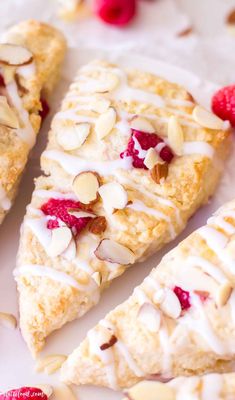 some food is laying out on a white plate with raspberries and almonds