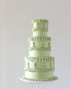 a three tiered cake with green frosting