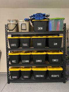 several bins are stacked on top of each other in a storage rack with the words snow, lights, trucks, and cleaning supplies