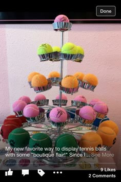 there are many different colored balls in the cupcake tower