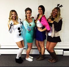 four women dressed up in costumes posing for the camera