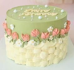 a green cake with pink flowers on it