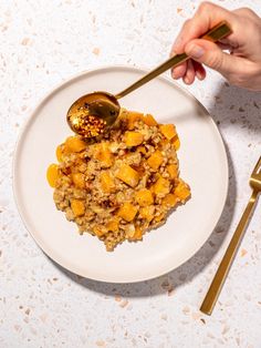 a white plate topped with food and a spoon