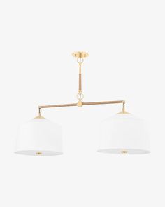 two white lamps hanging from a brass ceiling light fixture on an isolated wall in a living room or kitchen