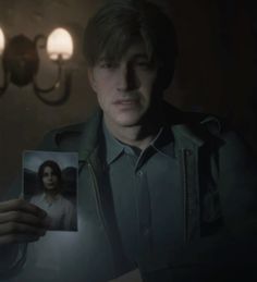 a man holding up a photo in the dark