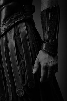 black and white photograph of man's arm with leather cuffs