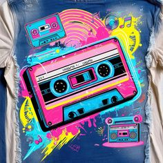 a t - shirt with an image of a cassette tape recorder on it, painted in pink and blue