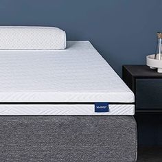 an image of a mattress that is in the middle of a bed with no sheets on it