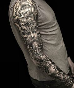 a man's arm with an octopus and ship tattoo on it