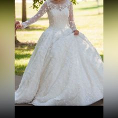 a woman in a wedding dress is posing for the camera