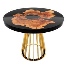 a black and gold side table with an artistic design on the top, sitting against a white background