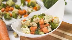 broccoli, cauliflower and carrots in a white bowl