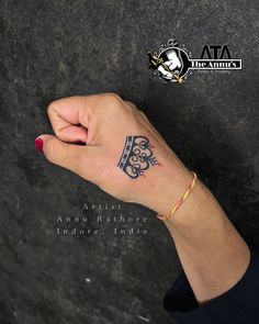 a woman's hand with a small tattoo on her left wrist and the words, artist ann rishore indore india