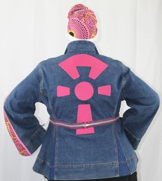 Handcrafted One-Of-A-Kind Introducing our Diasporic denim Jacket, a fusion of Afro-inspired fashion and cultural couture designed to celebrate Black heritage and African influence in contemporary attire. Crafted with meticulous detail, this jacket boasts a genuine leather applique of a stylized Ankh. The Ankh is an ancient Egyptian symbol of life and eternal existence. While the beauty of the Ankara fabric pays homage to Pan-African fashion, when combined with metal zippers, grosgrain ribbon tri Pink Denim Outerwear For Streetwear, Fitted Denim Patchwork Outerwear, Fitted Pink Denim Outerwear, Pink Fitted Denim Outerwear, Fitted Medium Wash Outerwear With Patchwork, Fitted Medium Wash Patchwork Outerwear, Medium Wash Fitted Patchwork Outerwear, Fitted Pink Denim Jacket With Long Sleeves, Pink Fitted Long Sleeve Denim Jacket