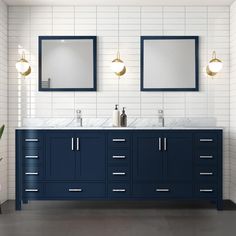 a bathroom with two sinks and mirrors on the wall