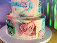 two tiered cake decorated with hearts and words