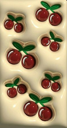 the cookies are shaped like cherries with green leaves