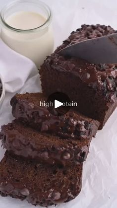 the chocolate cake is cut into slices and ready to be eaten with a glass of milk next to it