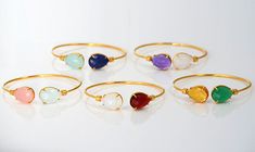 This bangle is a great gift for any mother. This adjustable bangle bracelet features two birthstones of your choice prong set in gold or silver plated brass. We love that this can gently be altered for the perfect fit on any wrist and is easily stackable with other jewelry or bangles. The gemstone size is 12 mm x 15 mm (0.4'' x 05''). METAL GOLD. 18k gold-plated brass. SILVER. Sterling silver plated brass. BIRTHSTONES I work with a variety of natural and synthetic gemstones to correlate to speci Adjustable Gemstone Bangle As Gift, Adjustable Bangle Bracelet With Birthstone, Adjustable Bangle Bracelets With Birthstone, Adjustable Birthstone Bangle Bracelet, Gold Bangle With Birthstone For Gift, Adjustable Gemstone Bangle For Wedding, Adjustable Gemstone Cuff Bracelet For Anniversary, Gold Bangle With Birthstone As Gift, Metal Wrapping