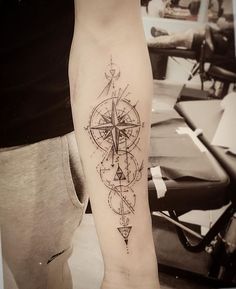 a person with a compass tattoo on their arm