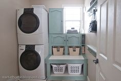 a washer and dryer in a small laundry room with baskets on the shelf