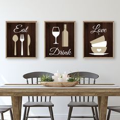 the dining room table is set with three framed art prints on the wall above it