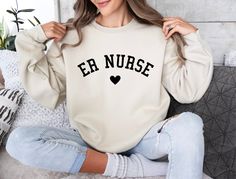 The perfect gift for a nurse that works in the emergeny department. Printed on our super soft, heavy blend crew neck sweaters. ♥ Material: 50% cotton, 50% polyester ♥ Medium-heavy fabric (8.0 oz/yd² or 271.25 g/m²) ♥ Loose fit ♥ No side seams Size guide and chart is available in photos. Feel free to contact me, if you have any questions or want to personalise something. Nurse Preceptor, Emergency Nurse, Picu Nurse, Nurse Week, Nursing Shirt, Nursing Hoodie, Pediatric Nurse, Emergency Nursing, Nurse Appreciation Gifts