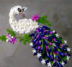 a peacock made out of flowers and leaves