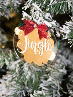 a glass ornament hanging from a christmas tree with the word jungle on it