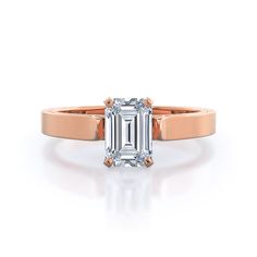 an emerald - cut diamond engagement ring in 18k rose gold, set with two claw prongs