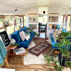 a living room filled with furniture and lots of plants