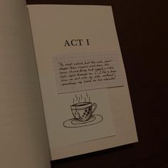 an open book with a drawing of a coffee cup on it