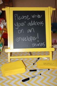 a blackboard with writing on it sitting on top of a table