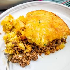 a white plate topped with a piece of pie and a fork on top of it