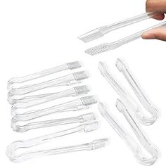 a hand is holding several toothbrushes in clear plastic