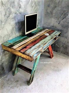 an old wooden desk with a computer on top