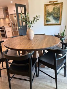 a wooden table with four chairs around it