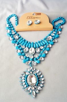 Signed with Tag, Ella Euro crystal rhinestone and aqua enamel pendant Statement necklace and pierced earrings set. Pierced earrings measure 1/2" by 3/8".Necklace adjusts from 18" to 21". Bib section measures 8" wide and tapers from 3/4" to 2 1/4" wide at the center, pendant measures 2 1/2" by 1 7/8" wide Antique Jewelry Necklace, Statement Pendant, Gorgeous Jewelry, Pierced Earrings, Earrings Set, Earings Piercings, Vintage Watches, Aqua Blue, Crystal Rhinestone