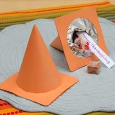 an orange cone with a sticker on it next to some candy and a piece of paper