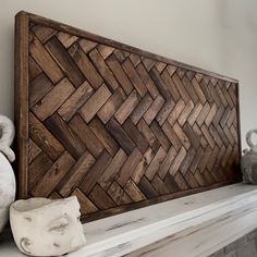 a wooden headboard sitting on top of a mantle next to vases and stuffed animals