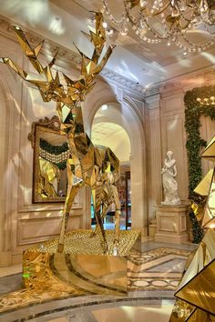 an elaborately decorated lobby with gold sculptures and chandeliers