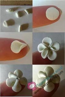 four different pictures of white flowers being made from clay and then placed on someone's finger