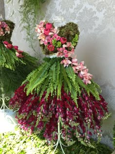 the dress is made out of flowers and moss