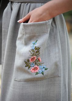 a close up of a person's pocket with flowers on it