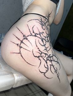 a woman's leg with barbed wire tattoo on the side and her lower thigh